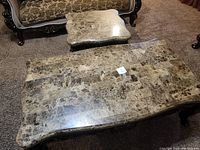 Overview of two coffee tables showing brown marble tops and dark cherry bases with carved cabriole legs and gold accents.