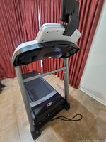 Front view of treadmill showing running belt, deck and undercarriage with NordicTrack logo visible