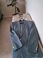 Men's tan London Fog coat displayed flat, showing front, with buttons and collar visible.