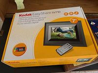 Front view of the Kodak EasyShare SV710 7-inch digital picture frame box showing product image and remote control.