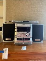 Full view of Aiwa stereo system with Daewoo DVD player on top, including speakers on both sides, showing front control panel and cassette decks