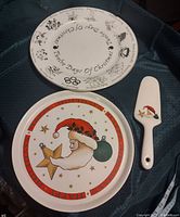 Photo showing both cake platters and the server on fabric.