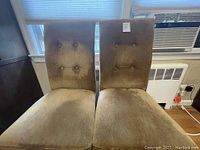 Two Parsons chairs side by side showing chenille fabric upholstery with button tufting and no visible stains or rips