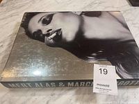 Front cover showing black and white image of a woman smoking, large glossy coffee table book