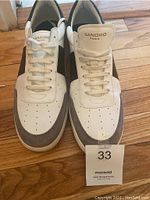 Pair of white and gray Sandro Paris sneakers from top, showing perforated toe box, laces, and Sandro branding on tongue. Size 11 indicated by seller.