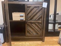 Front view with one door open revealing two internal drawers with metal label holders inside the cabinet.