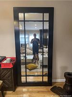 Front view of black framed mirror showing grid pattern