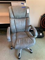 Front view of gray microfiber adjustable office desk chair showing padded seat, backrest, armrests, and caster wheel base.