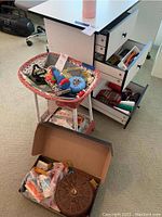 Overview photo showing various sewing notions inside a wicker basket and inside desk drawers.