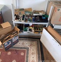 Two-tier shelf holding trays and boxes of stained glass pieces