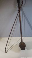 Full view of the Erhu instrument showing wooden neck, bow, and hexagonal python skin covered resonator body.