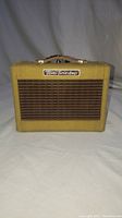 Front view showing Mini Twin Amp logo and yellow tweed fabric grille.