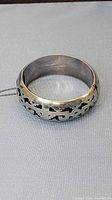 Front view of vintage silver bracelet showing detailed cutout design pattern