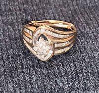 Front and top view showing heart shaped diamond cluster set in 10k gold band with ribbed sides