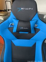 Close-up front view of the chair backrest and lumbar pillow showing E-WIN logo and blue black upholstery.