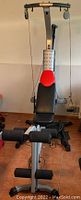 Front view of Bowflex Blaze Home Gym with bench and lat pulldown cable system visible