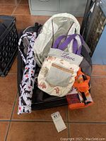 Overview photo showing all items included: Camelbak hydration pack, large Moose Racing gear bag, handmade tote, and pet pattern umbrella.