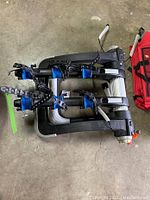 Thule trunk mount bike rack folded, showing three padded bike holders and adjustable arms.