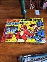 Rock'em Sock'em Robots boxed game with original colorful artwork showing two robots fighting and child players.
