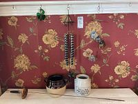 Photo showing wind chimes, ceramic pots, shamrock window hanging, and Spanish metal sword decor.