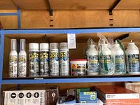Shelf with Flex Seal spray cans, Pro ready-mix concrete patch tub, and bottles of DAP Liquid Cement Crack Filler visible