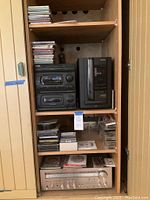 Full stereo setup with Aiwa CD changer beside Akai components and shelf of CDs