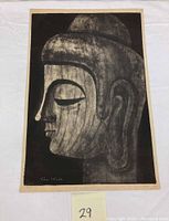 Full view of the ink block print depicting the Buddha face in profile on light-colored paper with dark ink.