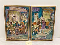 Pair of framed oil paintings showing German market and cafe scenes. Both signed by artist 'L. Amigam'.