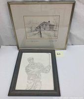 Two framed 19th century pencil drawings; one of a golfer in mid-swing, another landscape with rustic cabin
