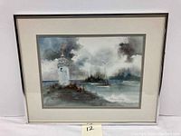 Full view of framed watercolor painting showing lighthouse, boats, seascape with stormy sky.