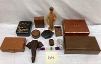 Collection of wooden and leather boxes including German figurine and smoking pipes