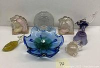 Photo showing the full collection including centerpiece dish, horse head bookends, purple bell, fish figurines, and Disney piggy bank.