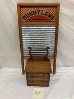 Full view showing the doll house washstand placed in front of the Sunnyland washboard.