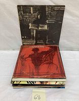 Stack of vintage vinyl LP records showing album covers including Graham Nash's Wild Tales and a red cover album.