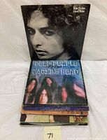 Stack of vintage vinyl LP records with Bob Dylan 'Hard Rain' and Deep Purple 'Machine Head' visible on top