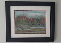 Framed pastel landscape painting showing a nature scene with trees, water, and mountains.