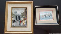 Both framed paintings side by side on black background: left is Pantheon Street scene in Paris, right is smaller signed aquarelle of waterside cityscape