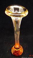 Full view of the tall art glass vase showing the orangey-ombre effect from clear at the top to orange base with controlled bubbles.