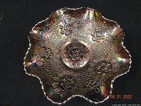 Top-down view of the Fenton black amethyst carnival glass bowl showing the full Cherry Chain pattern with five cherry medallions and intricate cable looping throughout the interior surface.