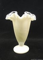 Front view of Fenton milk glass vase showing full shape and clear ruffle neck