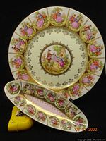 Full view of both plate and dish arranged together showing detailed artwork and gold trim