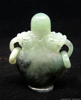 Front view of jadeite snuff bottle showing dragon motif and screw-top lid