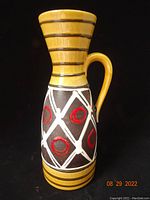 Front view of full vase with handle and geometric pattern