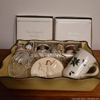 Photo showing the various holiday and wedding keepsake items in the lot within a yellow tray.