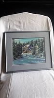 Full view of framed winter mill scene painting, showing the artwork, frame, and matting.