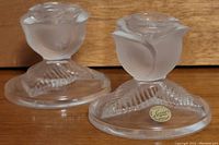 Pair of rose-shaped clear lead crystal candleholders with frosted petals and textured bases