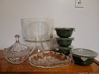 Photo showing all houseware items including glass and ceramic pieces on wooden surface
