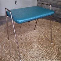 Full view of the retro vinyl stool showing turquoise vinyl seat with metal tubular legs