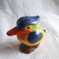 Front and side view of the ceramic kingfisher salt shaker showing detailed multicoloured paint and holes on blue head