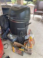 Full view of Charbroil The Big Easy combo cooker with cover, gas burner, and mesquite chips bag visible.